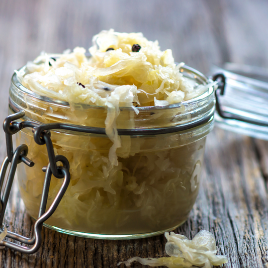 Image of a simple naked sauerkraut in an open clip top jar