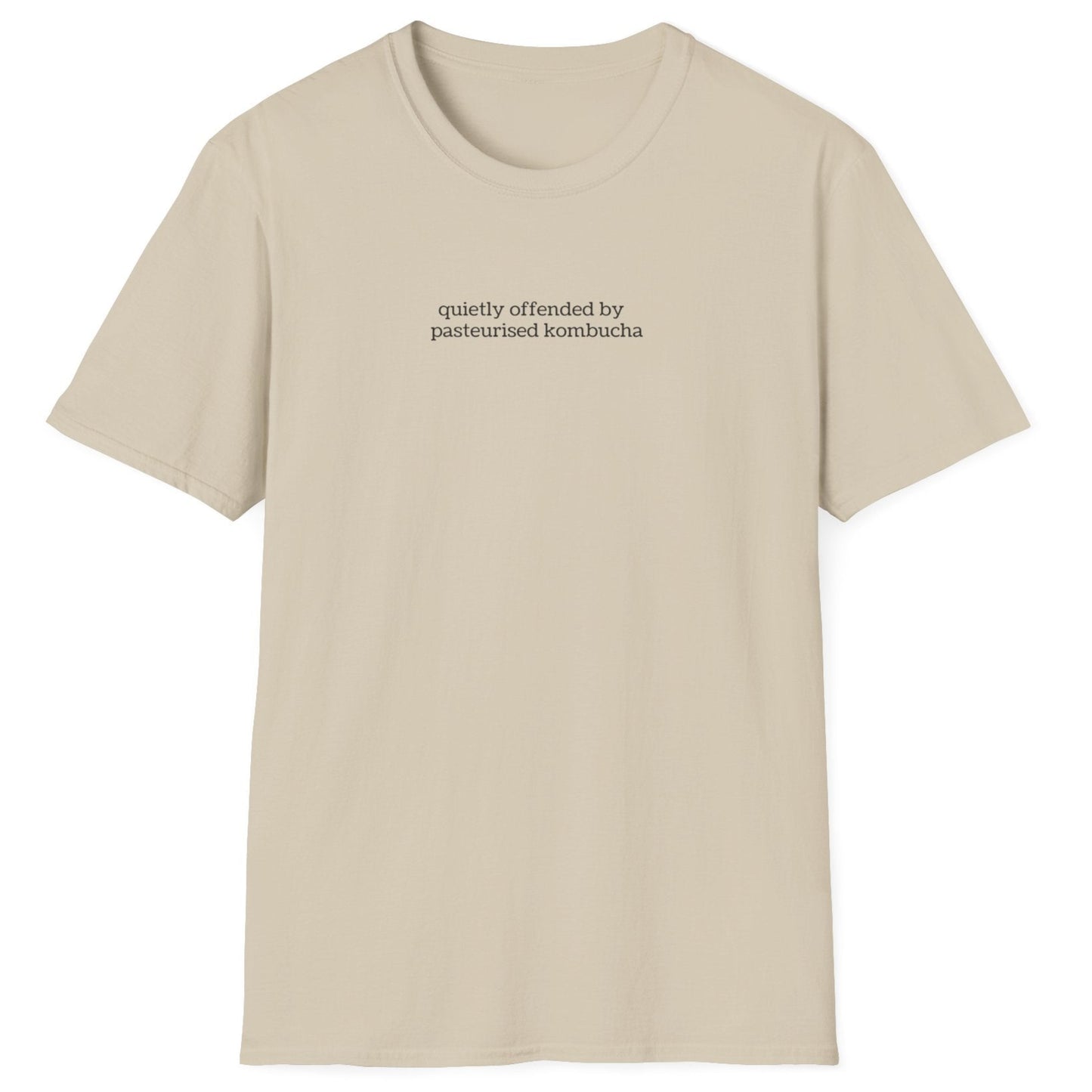 Minimalist neutral t-shirt with small lowercase black text reading “quietly offended by pasteurised kombucha” — designed for kombucha purists and low-key fermentation fans