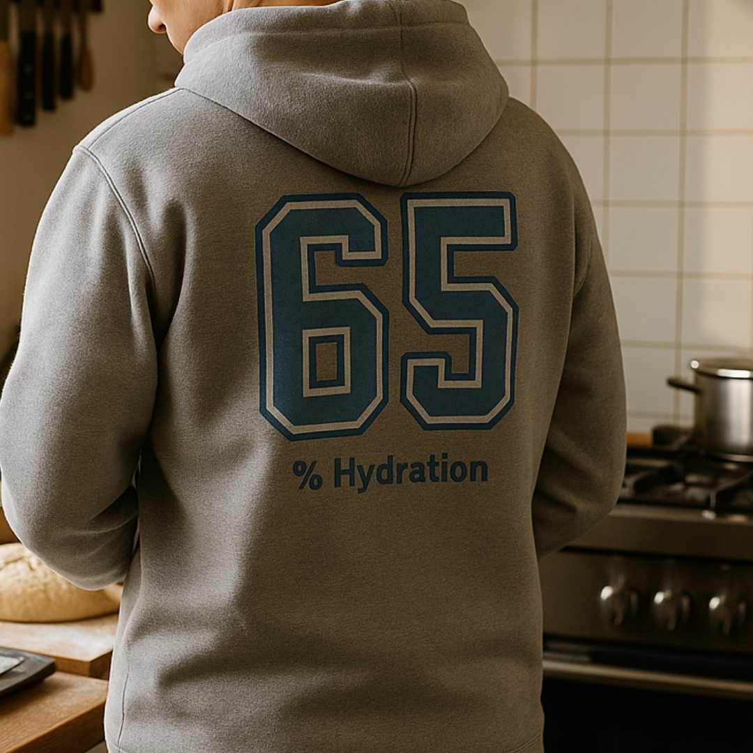 Lifestyle image of sourdough baker’s % Hydration hoodie, minimalist grey hoodie with bold varsity number back print