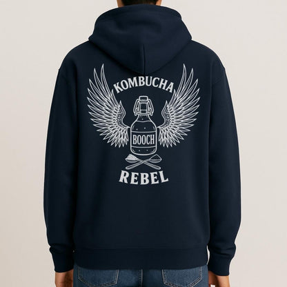 Mock-up of navy Kombucha Rebel back print hoodie for fans of fermentation, featuring a bottle of booch with dramatic wings and crossed spoons - one with tea leaves and one with sugar. Design inspired by vintage Harley Davidson jackets.
