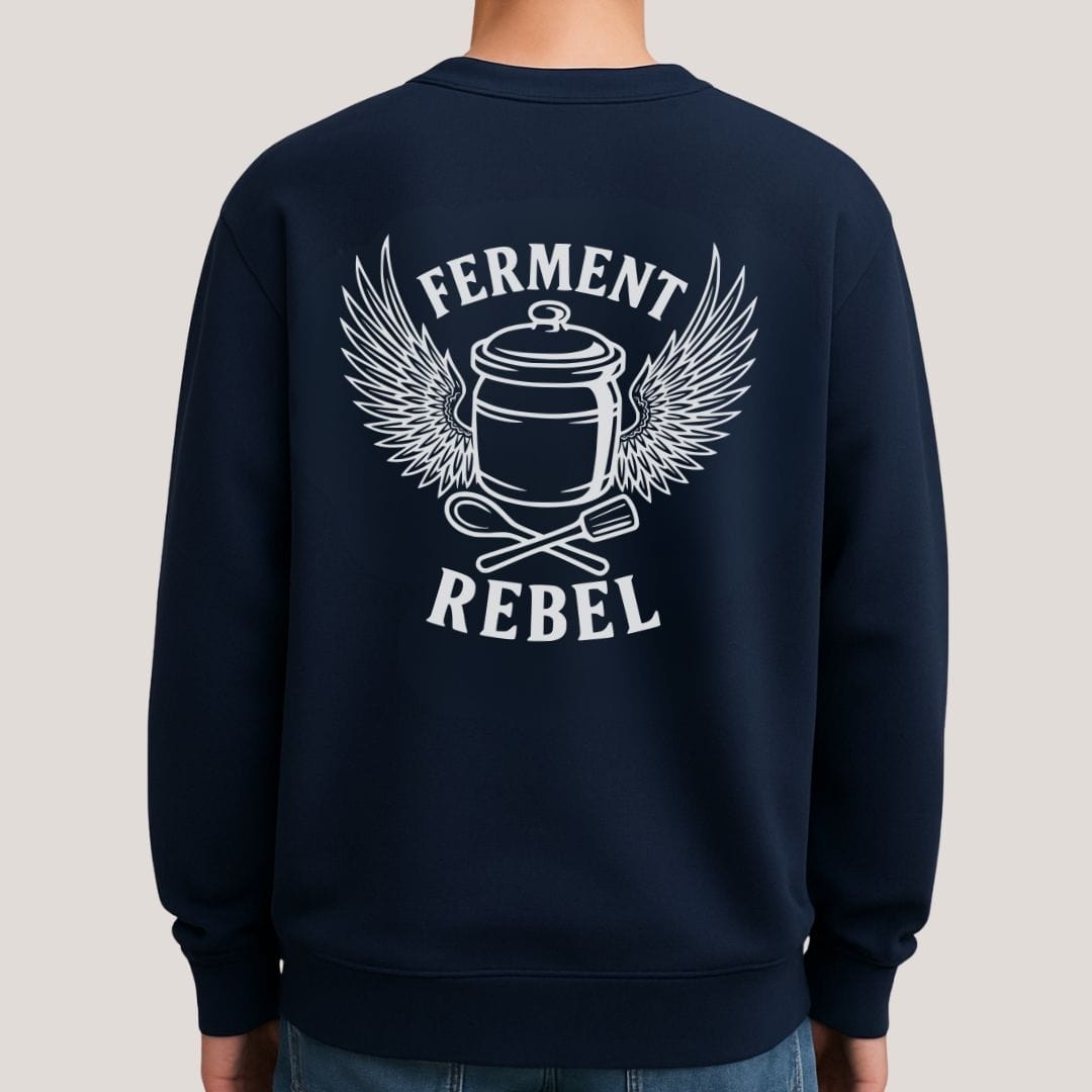 Mock-up of navy Ferment Rebel back print sweatshirt for fans of fermentation, featuring a ceramic crock with dramatic wings and crossed wooden spoon and tamper - tools of the trade. Design inspired by vintage Harley Davidson jackets.