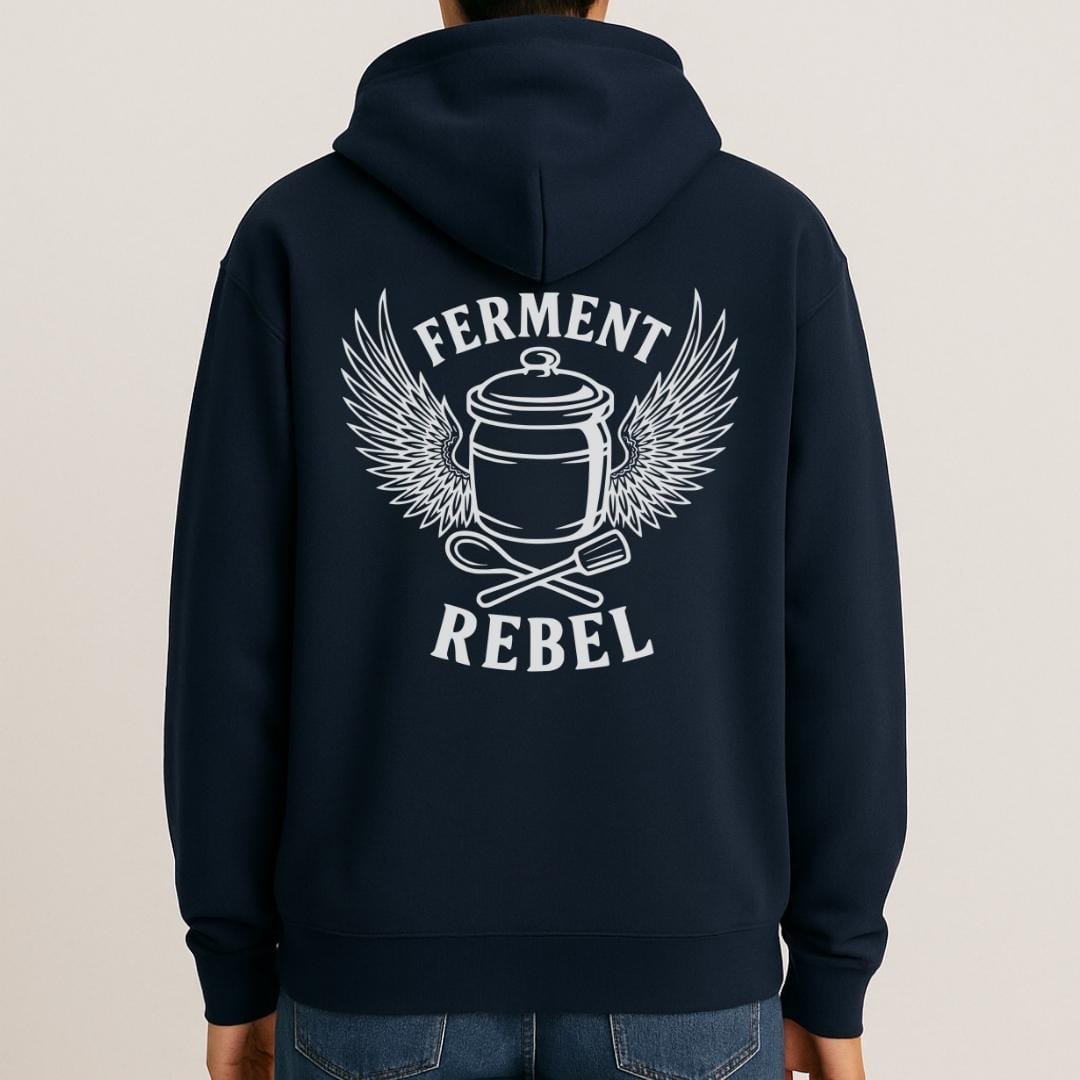 Mock-up of navy Ferment Rebel back print hoodie for fans of fermentation, featuring a ceramic crock with dramatic wings and crossed wooden spoon and tamper - tools of the trade. Design inspired by vintage Harley Davidson jackets.