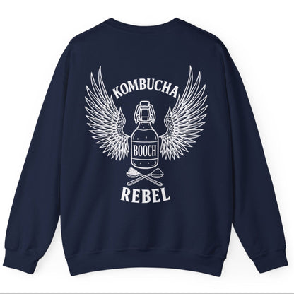 Navy Kombucha Rebel back print sweatshirt for fans of fermentation, featuring a bottle of booch with dramatic wings and crossed spoons - one with tea leaves and one with sugar. Design inspired by vintage Harley Davidson jackets.