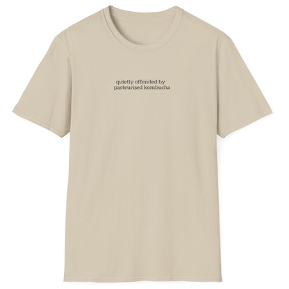 Minimalist neutral t-shirt with small lowercase black text reading “quietly offended by pasteurised kombucha” — designed for kombucha purists and low-key fermentation fans