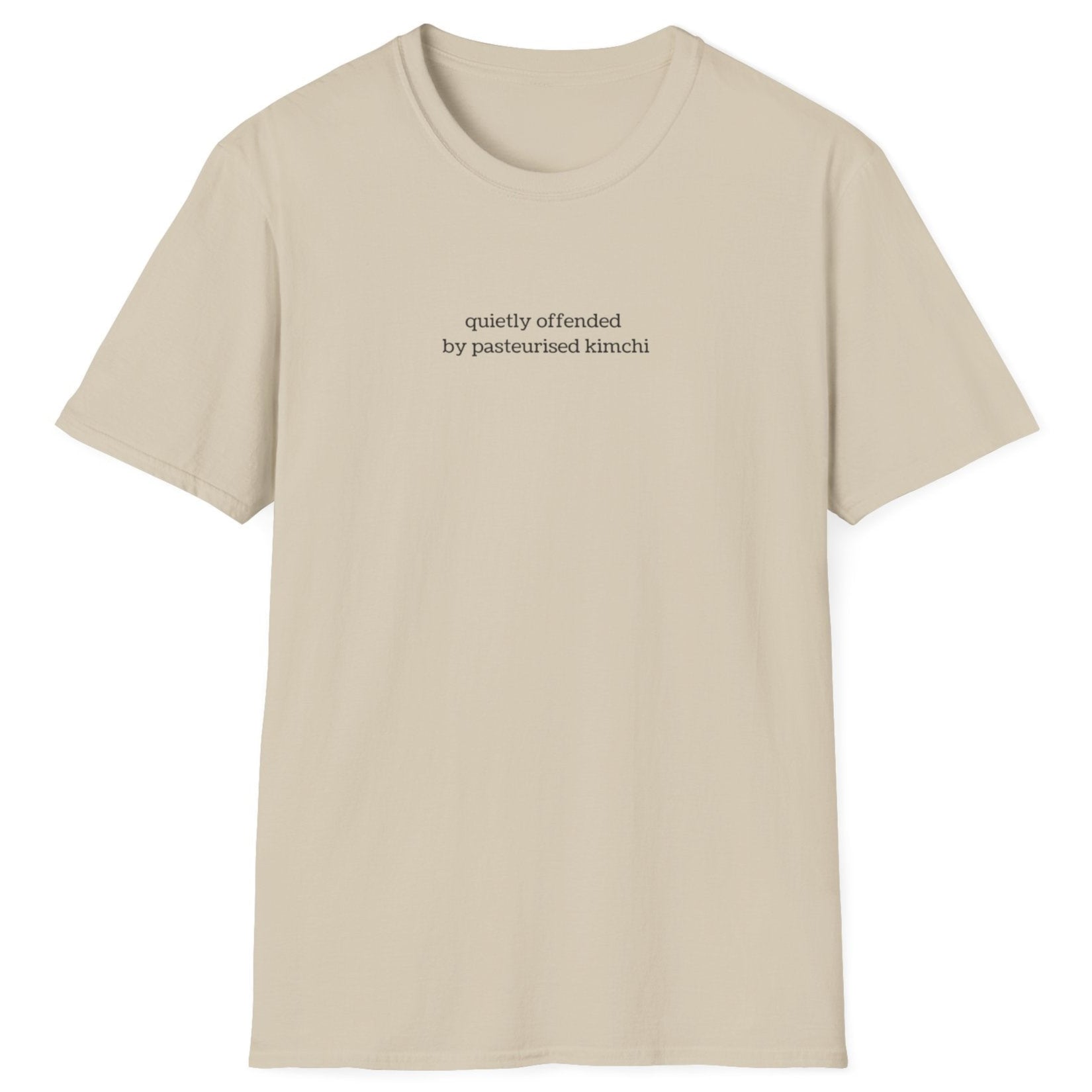 Minimalist neutral t-shirt with lowercase black text reading “quietly offended by pasteurised kimchi” — subtle tee for wild fermenters and cultured food fans.